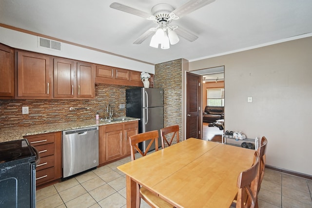 4202 62nd St Unit 6, Urbandale, IA 50322 - kitchen featuring a sink, appliances with stainless steel finishes, decorative backsplash, and light tile patterned flooring