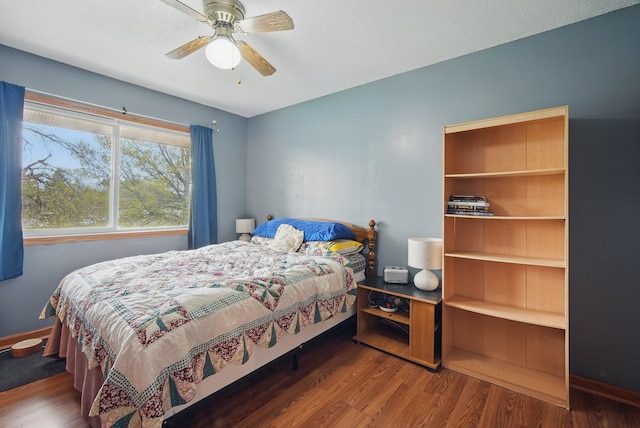 4202 62nd St Unit 6, Urbandale, IA 50322 - bedroom featuring a ceiling fan, baseboards, and wood finished floors