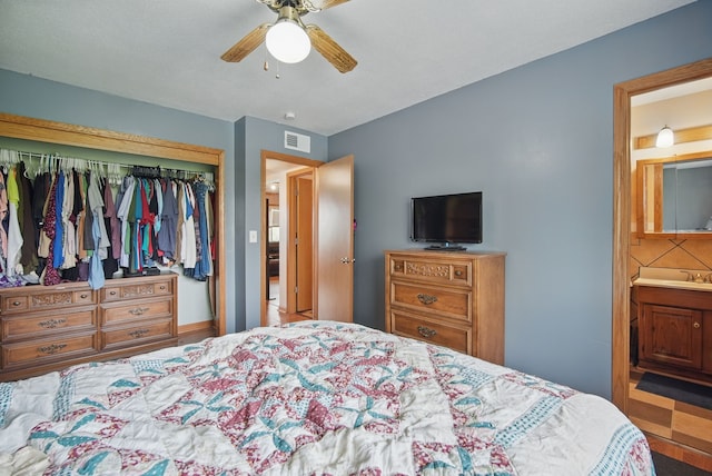 4202 62nd St Unit 6, Urbandale, IA 50322 - bedroom with a ceiling fan, visible vents, a sink, a closet, and ensuite bathroom