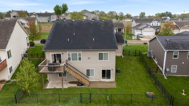 rear view of property featuring a patio, a residential view, a fenced backyard, and a deck