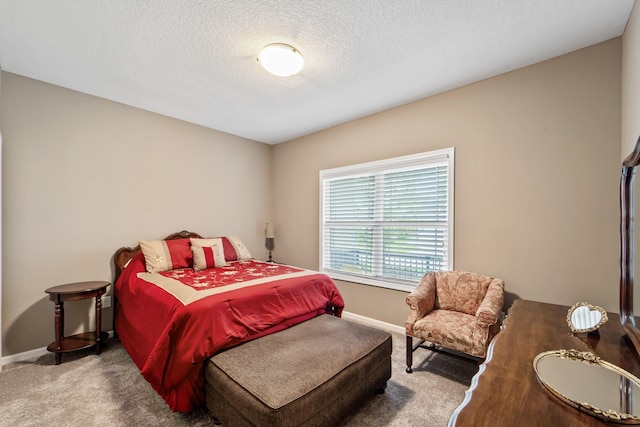 carpeted bedroom with a textured ceiling and baseboards