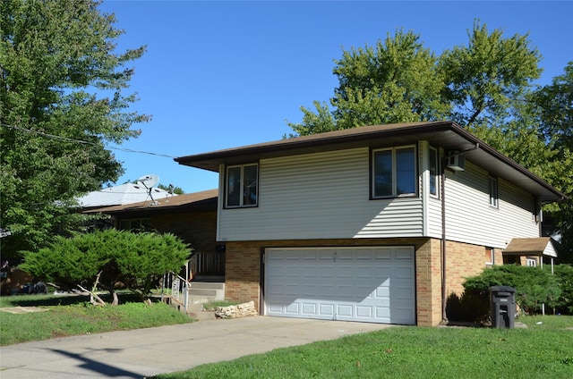 tri-level home featuring an attached garage, concrete driveway, a front yard, and brick siding