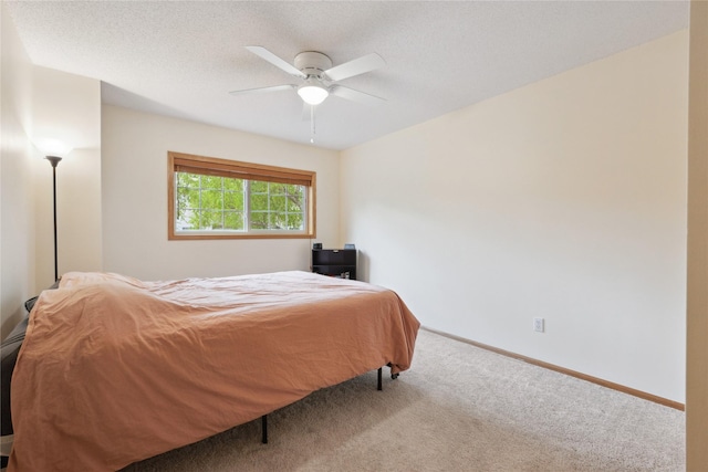 carpeted bedroom with baseboards and a ceiling fan