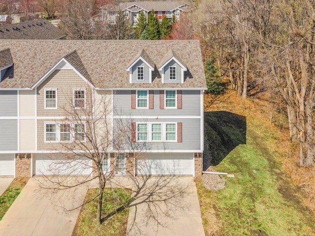 5553 Kenton Ln, Johnston, IA 50131 - view of front of property with a garage, driveway, and roof with shingles