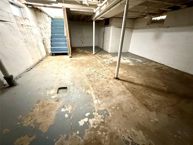 unfinished basement featuring stairs