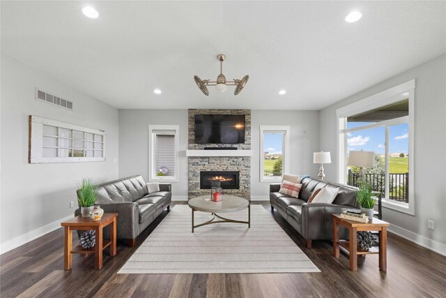 5129 NE Seneca Dr, Ankeny, IA 50021 - living area featuring a fireplace, dark wood finished floors, a ceiling fan, and recessed lighting