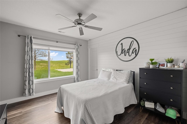5129 NE Seneca Dr, Ankeny, IA 50021 - bedroom with wood finished floors, ceiling fan, and wood walls