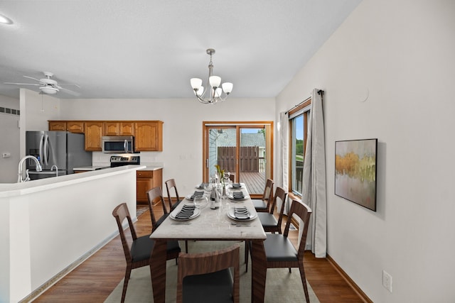 5099 Clover Ridge Rd, Panora, IA 50216 - dining area with baseboards, ceiling fan with notable chandelier, dark wood-style floors, and visible vents