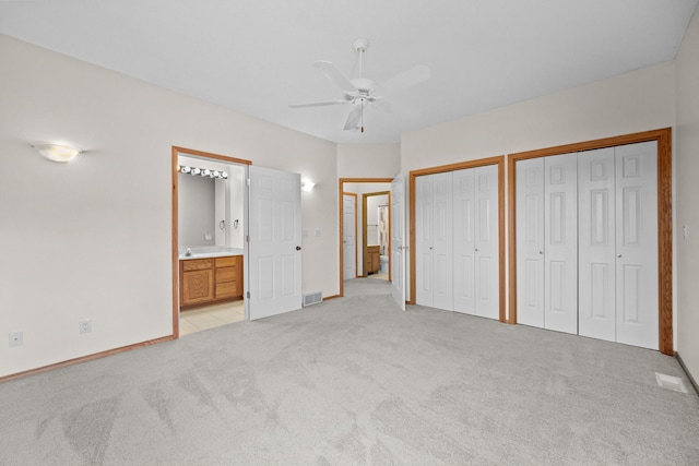 5099 Clover Ridge Rd, Panora, IA 50216 - unfurnished bedroom with light colored carpet, baseboards, ensuite bathroom, and two closets