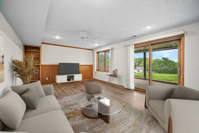 5099 Clover Ridge Rd, Panora, IA 50216 - living room featuring visible vents, a ceiling fan, wood finished floors, and a wainscoted wall