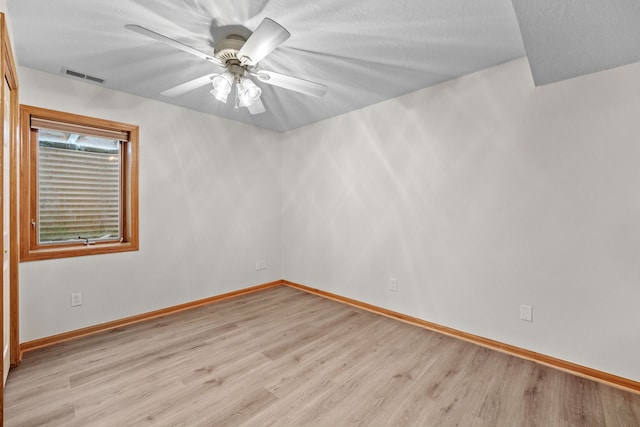 5099 Clover Ridge Rd, Panora, IA 50216 - spare room featuring baseboards, ceiling fan, light wood-type flooring, and visible vents