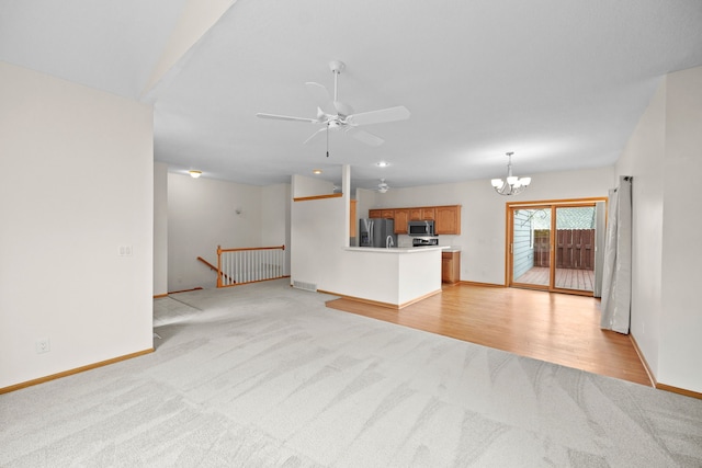 5099 Clover Ridge Rd, Panora, IA 50216 - unfurnished living room featuring baseboards, visible vents, light carpet, and ceiling fan with notable chandelier