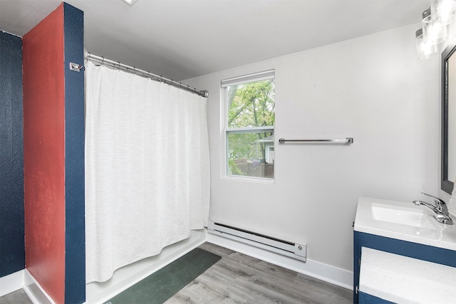 full bathroom with vanity, a shower with shower curtain, wood finished floors, and baseboard heating