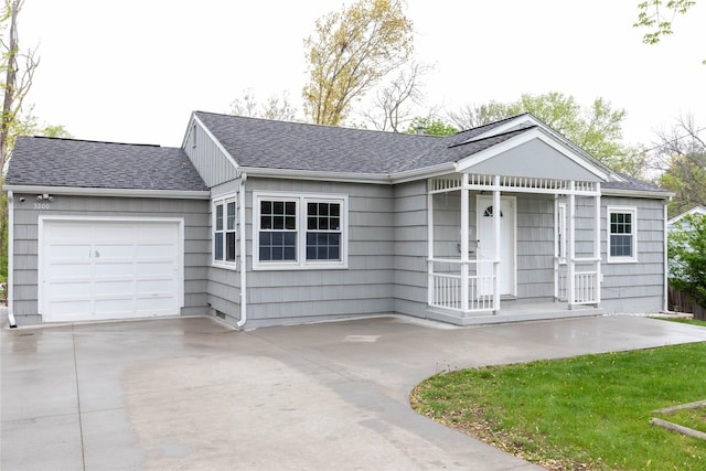 ranch-style home featuring an attached garage, roof with shingles, and driveway