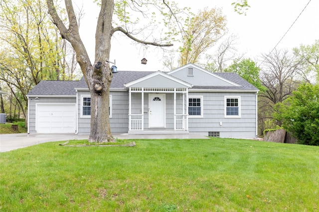 ranch-style house with a shingled roof, an attached garage, concrete driveway, and a front lawn