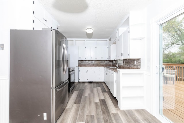 kitchen featuring open shelves, a sink, white cabinetry, and stainless steel appliances