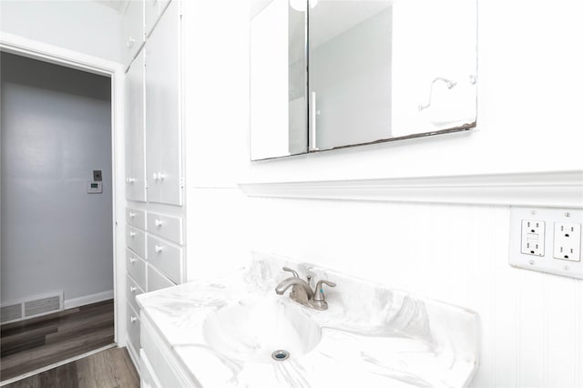 bathroom with visible vents, wood finished floors, and vanity