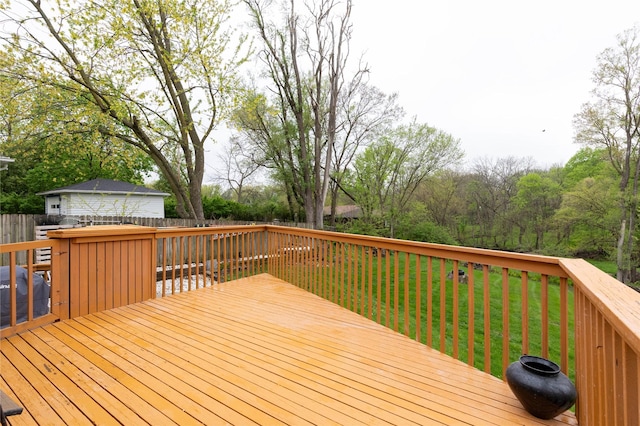 wooden terrace featuring a lawn and a fenced backyard