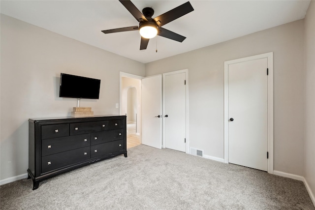 bedroom with visible vents, baseboards, and light colored carpet