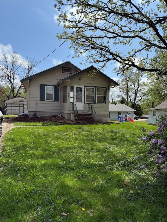 bungalow-style house with entry steps and a front yard