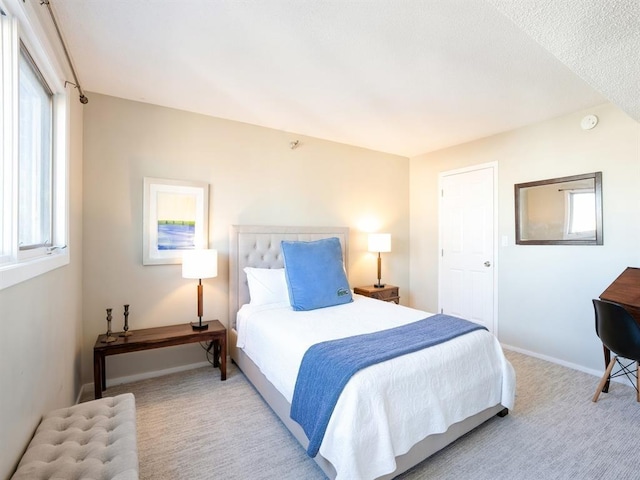 300 Walnut St Unit 1407, Des Moines, IA 50309 - bedroom with baseboards and carpet