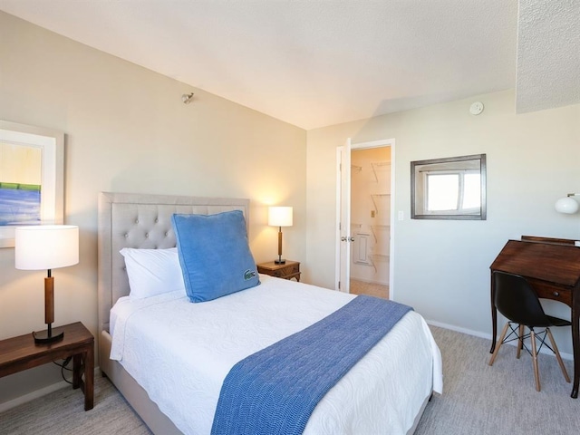 bedroom featuring baseboards and light carpet