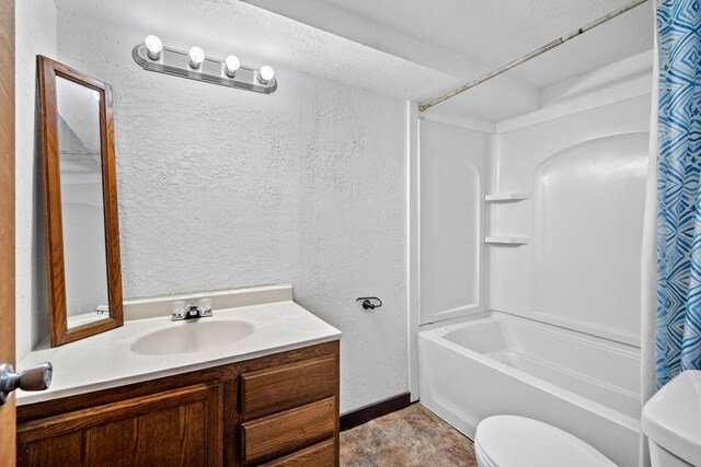 full bath featuring vanity, a textured wall, toilet, and shower / tub combo with curtain