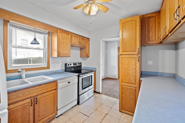 kitchen with pendant lighting, stainless steel range with electric stovetop, ceiling fan, a sink, and dishwasher