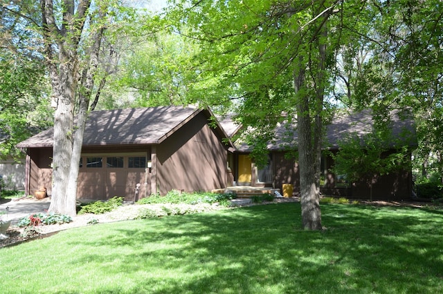 view of property exterior featuring a lawn and a shingled roof
