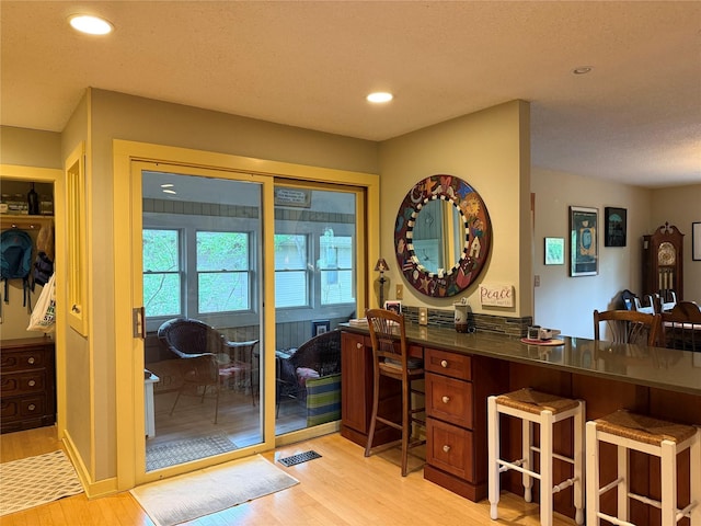 interior space with recessed lighting, light wood finished floors, and visible vents
