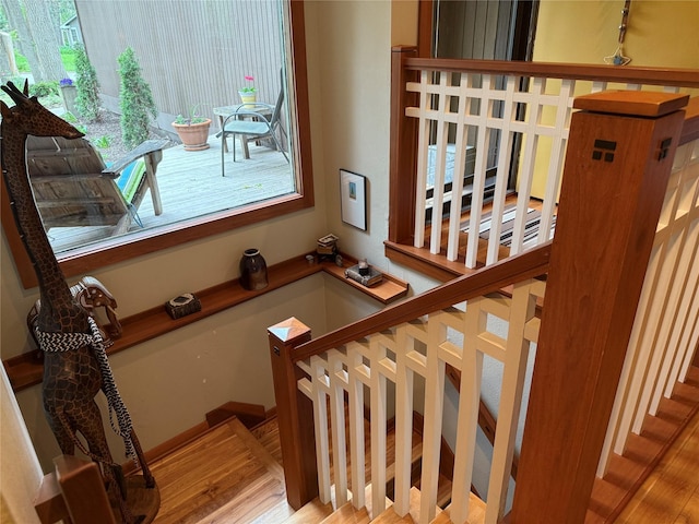 stairs featuring wood finished floors