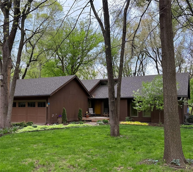 956 55th St, West Des Moines, IA 50266 - mid-century modern home featuring a garage, roof with shingles, and a front lawn