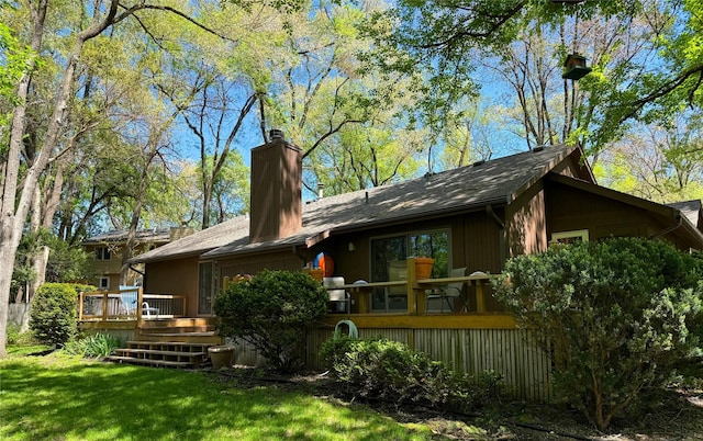 956 55th St, West Des Moines, IA 50266 - back of house with a chimney, a wooden deck, and a yard