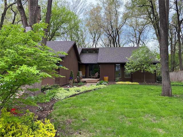 956 55th St, West Des Moines, IA 50266 - back of house with a shingled roof and a yard