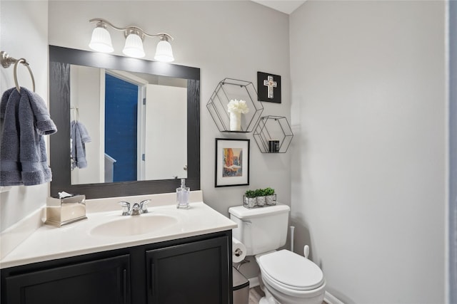 half bath featuring toilet and vanity