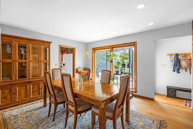 dining room with light wood-style floors, baseboards, and recessed lighting