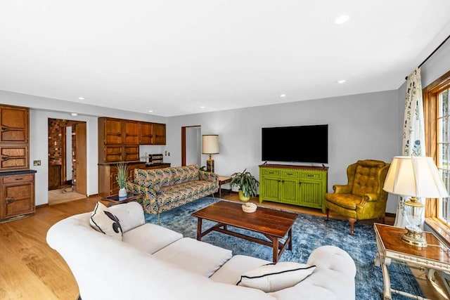living room with light wood-style floors and recessed lighting