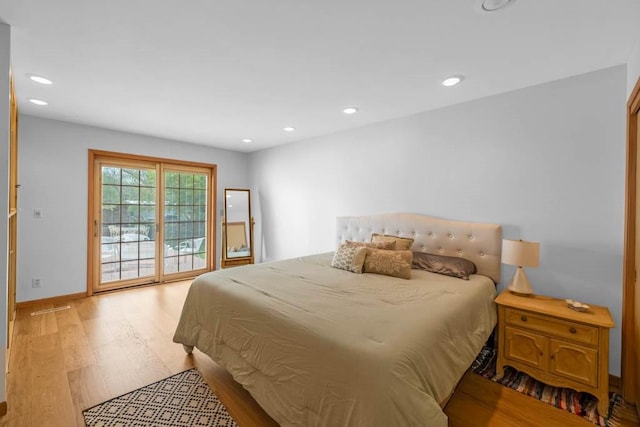 bedroom with recessed lighting, light wood-style flooring, baseboards, and access to exterior