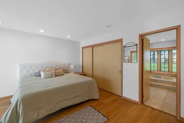 bedroom featuring a closet, recessed lighting, and light wood finished floors