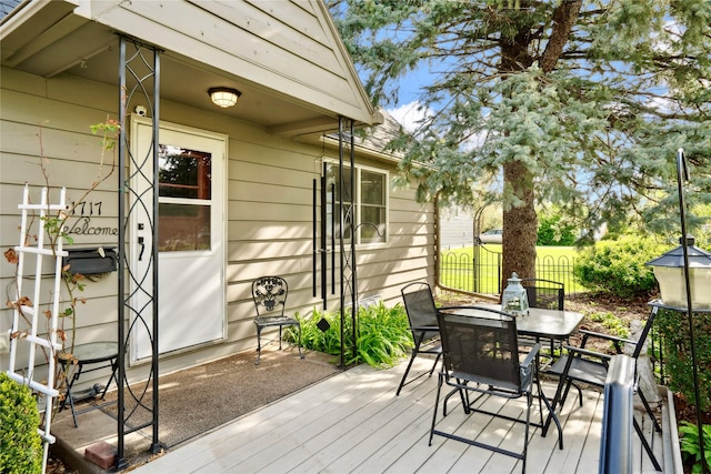 deck featuring fence and outdoor dining space
