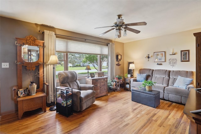 living room with ceiling fan and light wood-style floors