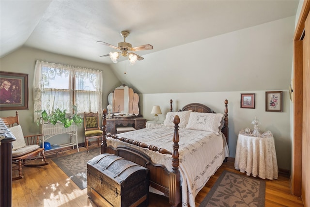 bedroom featuring radiator, ceiling fan, vaulted ceiling, and wood finished floors