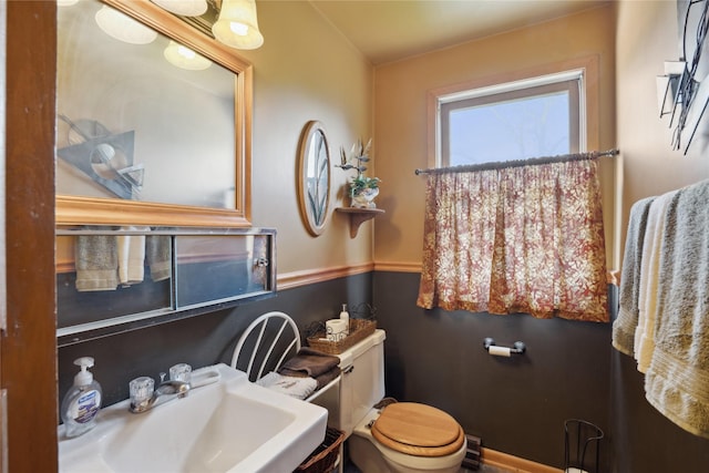 half bathroom with a sink and toilet