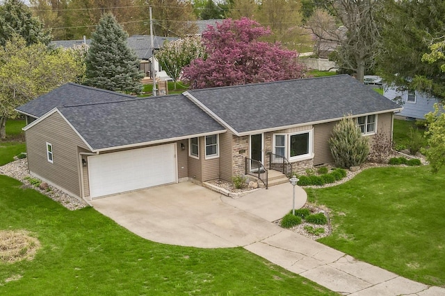 ranch-style home featuring a shingled roof, an attached garage, driveway, and a front yard