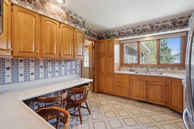 kitchen with plenty of natural light, a sink, light floors, and light countertops