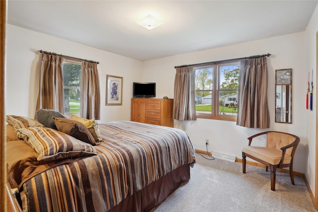 carpeted bedroom featuring baseboards