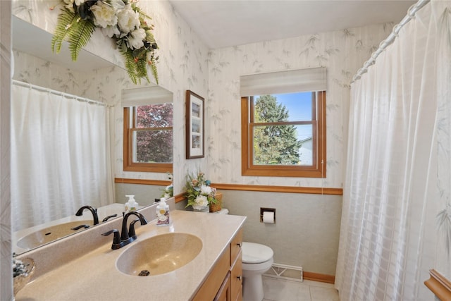 bathroom with toilet, wallpapered walls, tile patterned floors, and vanity