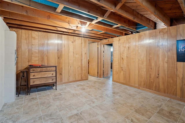 finished basement featuring wooden walls