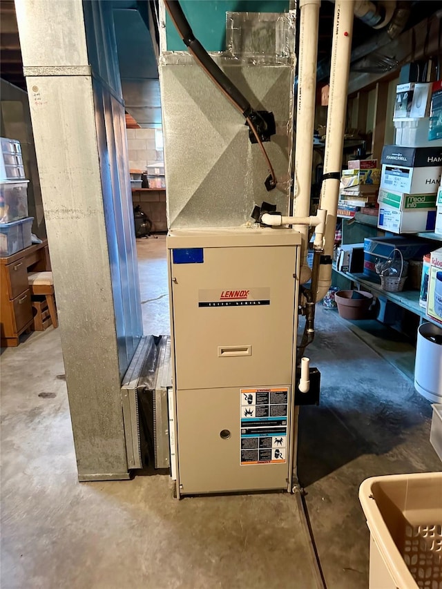 utility room featuring heating unit