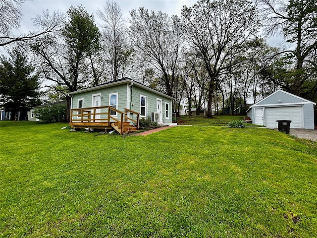 3825 15th St, Des Moines, IA 50313 - view of grassy yard featuring a detached garage, a wooden deck, and an outdoor structure